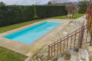 a swimming pool in a yard with a fence at Quinta do Giestal in Aborim