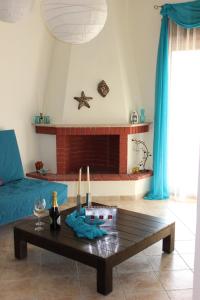 a living room with a coffee table in front of a fireplace at Siviri Apartment in Blu in Siviri +20 photos