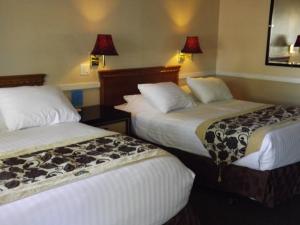 Ένα ή περισσότερα κρεβάτια σε δωμάτιο στο Sage Motel