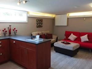 a living room with a red couch and a red sofa at Bradford Vacation in Bradford +6 photos