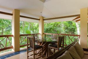 a dining room with a table and chairs on a balcony at Casa Monos Locos - Portasol Vacation Rentals in Portalón