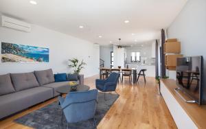 a living room with a couch and a table at Villa MirA with fantastic sea view in Makarska