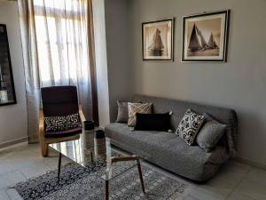 a living room with a couch and a chair at Dali Rooms in Chania