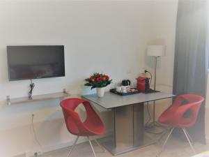 een kamer met een tafel en twee rode stoelen bij Haarlem 49 in Haarlem