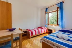 Ein Bett oder Betten in einem Zimmer der Unterkunft Apartmani Bruno