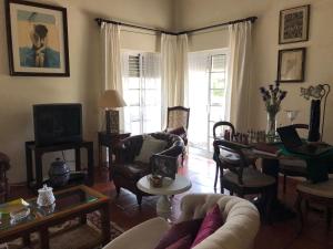a living room with a couch and chairs and a table at Quinta Nova do Almeida in Alcobaça