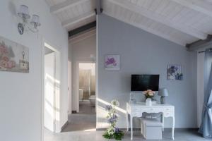 a living room with a white table and a tv at DUSSAIGA - La casa di Rina in Dolceacqua