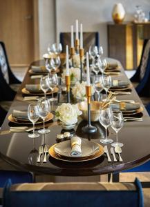 a long table with plates and wine glasses on it at L'Ermitage Beverly Hills in Los Angeles