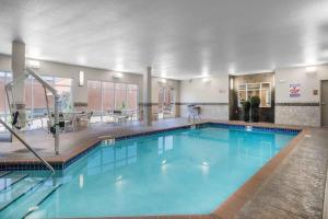 a large swimming pool in a hotel room at AmericInn by Wyndham Windom in Windom