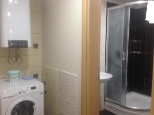 a bathroom with a washing machine and a sink at Seyran Seaside Apartments- 2-garden floor in Trabzon