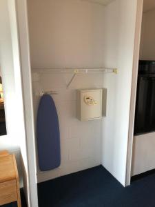 a bathroom with a toilet with a blue lid at Beachcomber Motel in Ocean City