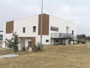a white building on top of a field at RM newhost 2015 / CasaDoChico in Portalegre
