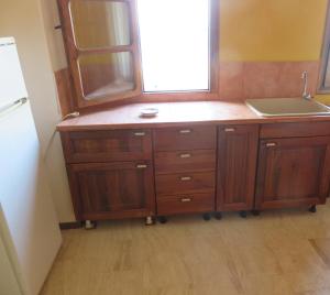 a kitchen with a sink and a wooden cabinet at Best view in Polychrono - Families Only in Polychrono +107 photos
