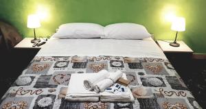 a bed with two lamps and towels on it at B&B Sant'Angelo in Licata