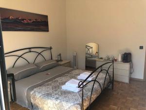 a bedroom with a bed and a mirror at Casa Ines in Bellinzona