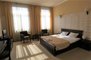Postel nebo postele na pokoji v ubytování Hotel Neptun