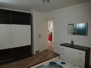a living room with a dresser and a tv at Apartment LANA Kaštel Stari in Kaštela