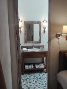 a bathroom with a sink and a mirror at Candelaria House Boutique in Bogotá