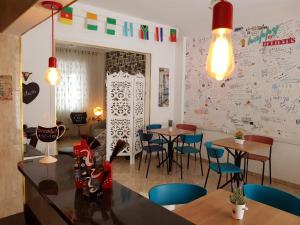 a restaurant with tables and chairs and a white wall at HostelariaSP Boutique in São Paulo
