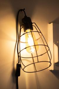 a light that is hanging on a wall at Pinehill Rooms in Reading