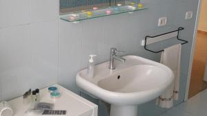 a bathroom with a white sink and a mirror at Casa Castellano in Nola