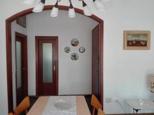 a dining room with a table and a mirror at Appartamento MiMa Pineta in Milano Marittima +15 photos