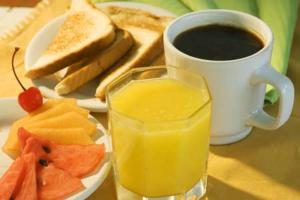 a cup of coffee and a plate of fruit and toast at Eco Boutique Hotel Vista Las Islas Reserva Natural in Paquera