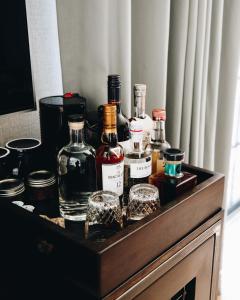 a wooden box with bottles and glasses on a table at The Ramble Hotel in Denver