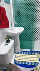 a bathroom with a sink and a toilet and a shower at Chalés Porto do Céu in Aracati
