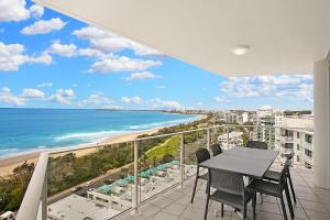 a balcony overlooking a beach with a view of the ocean at Catalina Resort in Maroochydore
