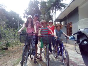 a group of people riding bikes on a path at Priyanna Guest, Forest view in Polonnaruwa