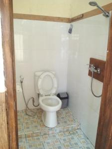 a bathroom with a toilet and a shower at Rumah Daun Homestay Tetebatu in Tetebatu