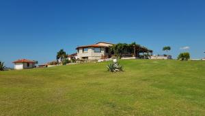 a house sitting on top of a lush green field at Villa Iviritiko in Nea Roda