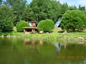 a view of a lake with a house and trees at Saunaranta in Rymättylä