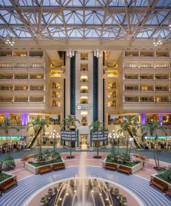 
a large building with a clock in the middle of it at Hyatt Regency Orlando International Airport Hotel in Orlando
