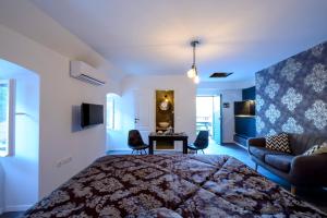 Un dormitorio con una cama y una sala de estar. en Studio Apartments La Bohème, en Dubrovnik