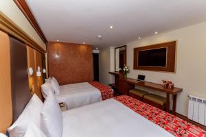 Letto o letti in una camera di Yawar Inka Hotel
