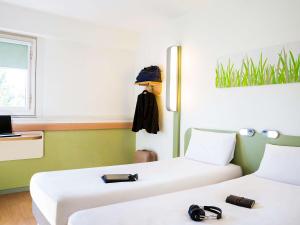 Postel nebo postele na pokoji v ubytování ibis budget Toulouse Centre Gare