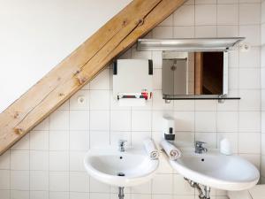 a bathroom with two sinks and a mirror at Hostel Situla in Novo Mesto