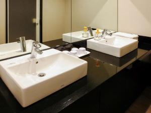 a bathroom with two sinks and a mirror at ibis Styles Osaka Namba in Osaka