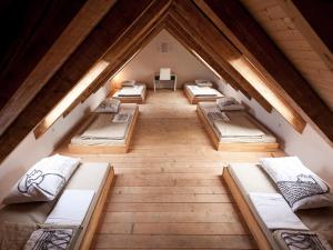 an overhead view of a room with six beds in a attic at Hostel Situla in Novo Mesto
