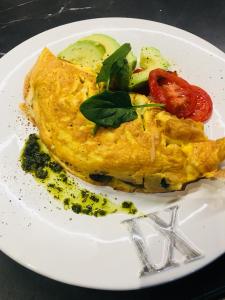 a white plate with an omelet with tomatoes and vegetables at Franklin38 in Auckland