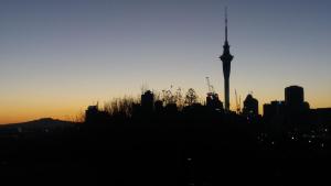 a silhouette of a city skyline with the television tower at Franklin38 in Auckland