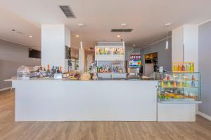 a large white counter in a store with food at Villa Delfa in Caorle
