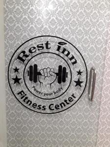 un tercer letrero del centro de fitness en una puerta en Restinn Hotel, en Maulvi Bāzār