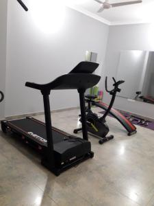 a room with a gym with a treadmill and a bike at Restinn Hotel in Maulvi Bāzār