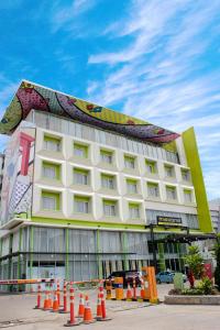 a building with a mural on the side of it at MaxOneHotels.com at Vivo Palembang in Palembang