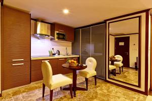 a kitchen with a dining room table and chairs at Six Seasons Hotel in Dhaka