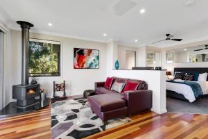 a living room with a couch and a bed at Tranquillity at Ravensbourne Escape in Ravensbourne