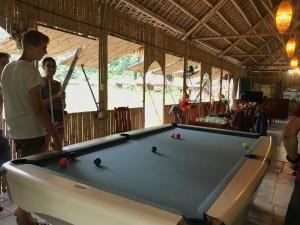 a man and woman standing next to a pool table at Ninh Binh Valley Homestay in Ninh Binh